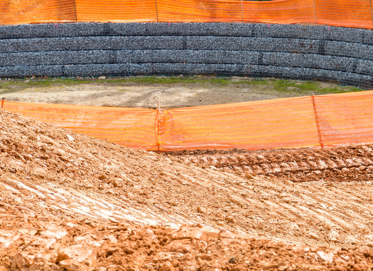 Silt fence around a retention pond on a construction site.