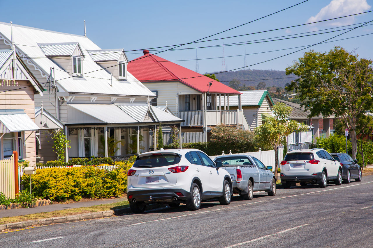 Paddington streetscape of character houses with on-street parking.