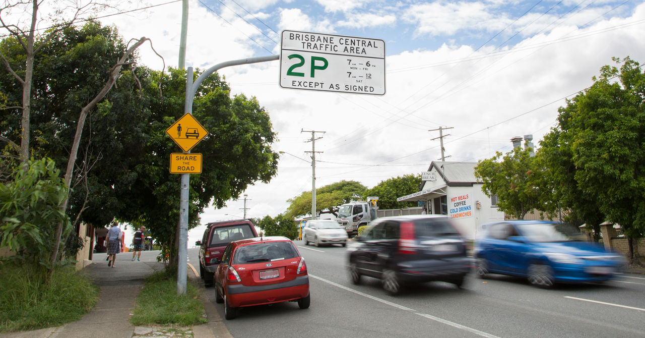 Cars parked near a yellow line in Brisbane Central Traffic area.