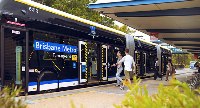 Metro at busway station with passengers boarding