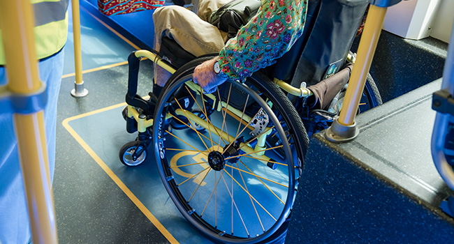 Passenger in wheelchair in designated wheelchair space onboard a metro vehicle