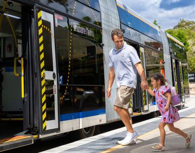 Father and daughter boarding metro