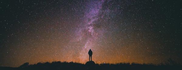 Person, silhouette and night sky with stars