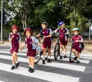 Group of school children walking across a zebra crossing