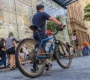 Man pushing his bicycle along Queen Street Mall